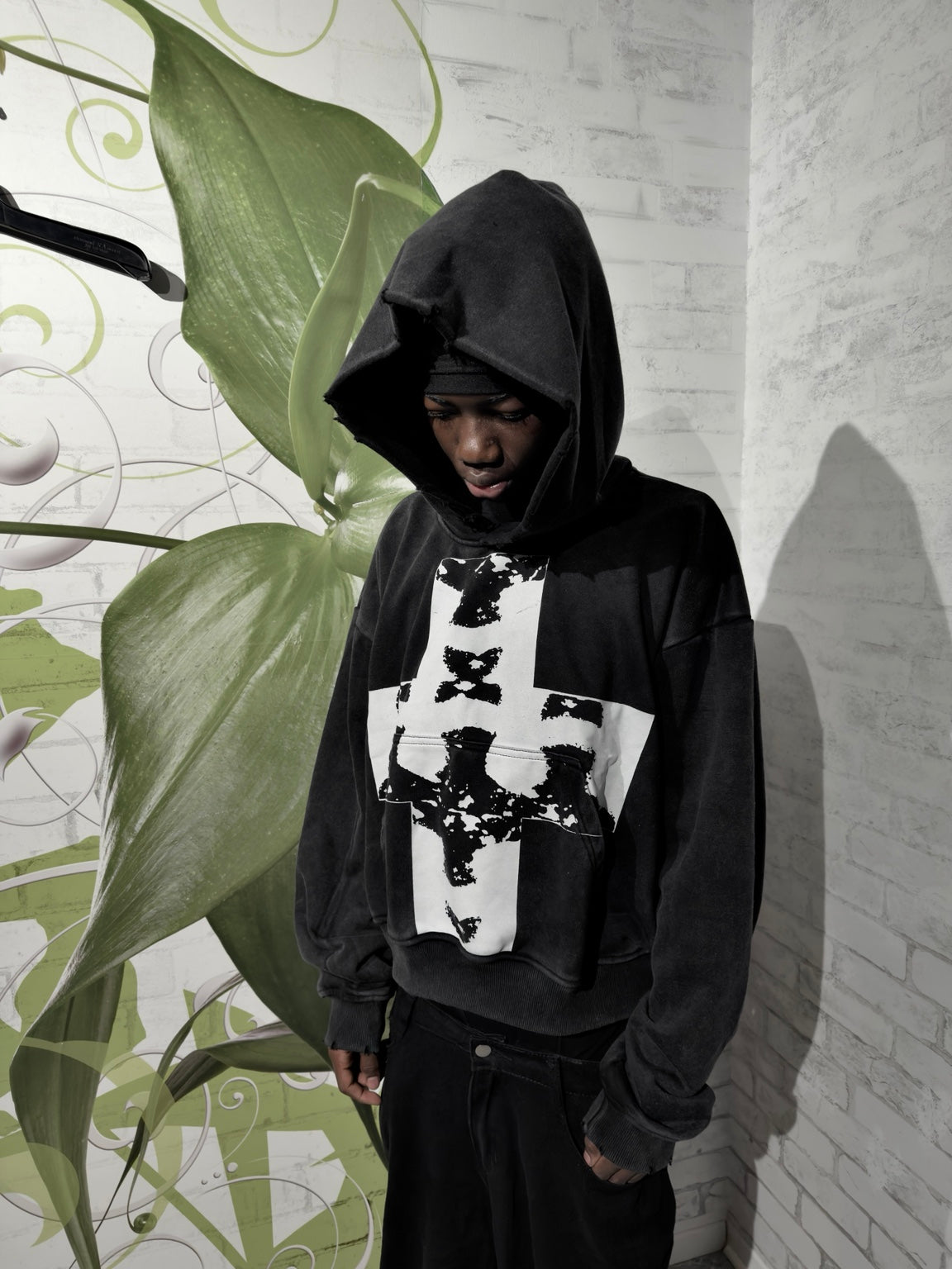 Missing Faces Hoodie on model with hood up